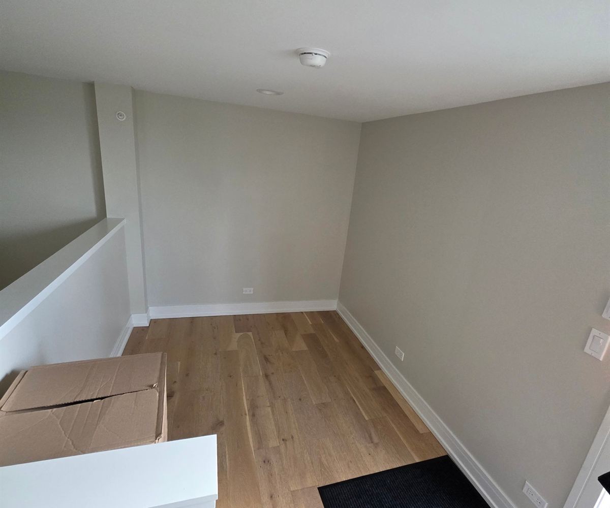 The room before the wet bar was built: bare walls and new white oak flooring